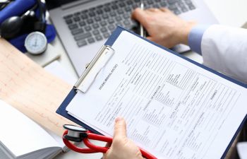 A doctor reviewing medical records.